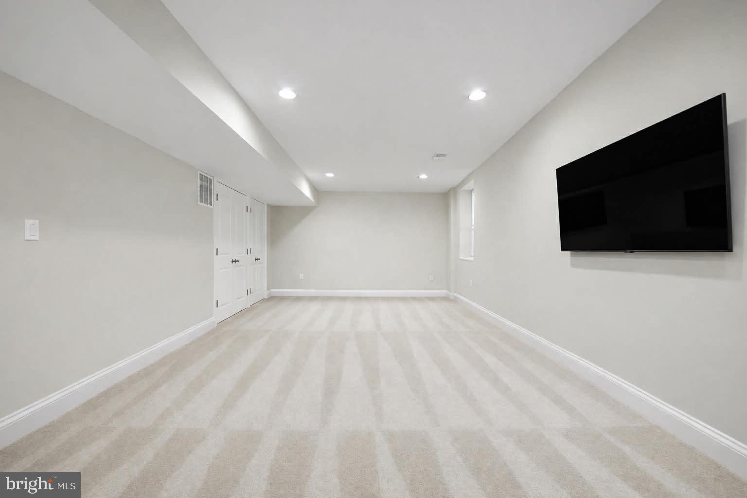 118 Ackerman Lane Ruther Glen, VA 22546 - Photo 28 of 57 a view of an empty room with a flat screen tv