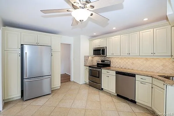 a kitchen with stainless steel appliances granite countertop a refrigerator sink and cabinets