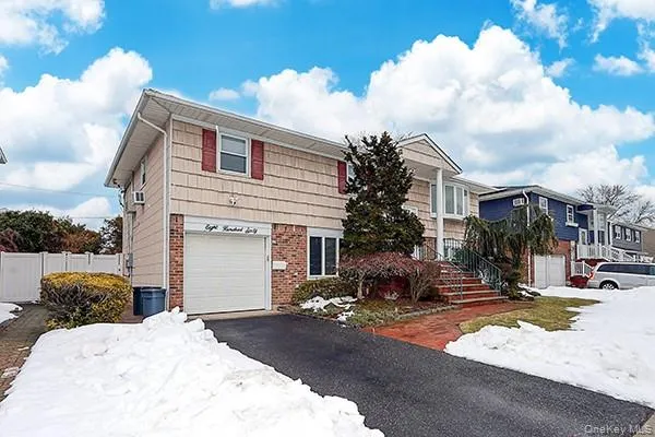 a front view of a house with cars