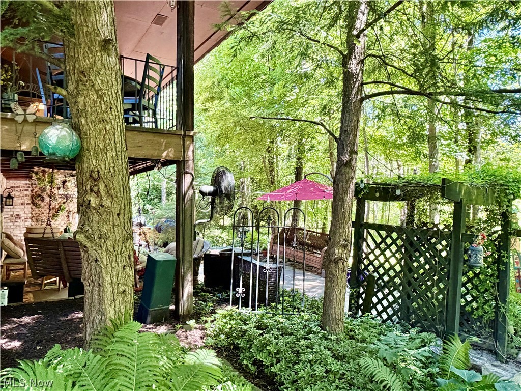 171 Granger Road, Unit 107 Medina, OH 44256 - Photo 38 of 41 Upper-level balcony with black iron railing & lower back patio where the fun begins.