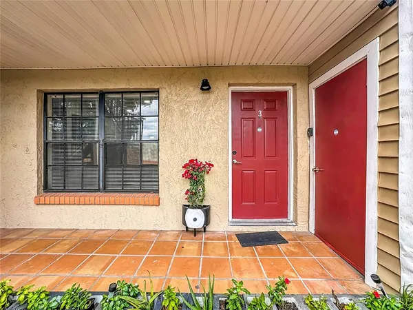 a view of a house with a patio and a yard