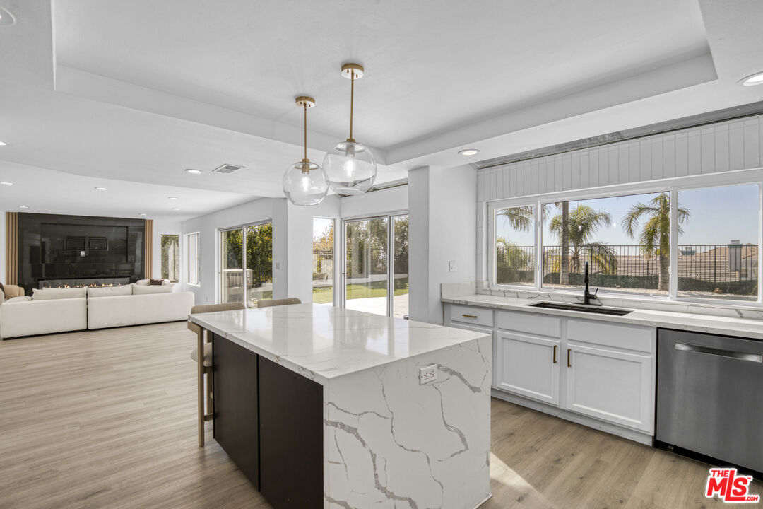 19668 Pine Valley Way Porter Ranch, CA 91326 - Photo 16 of 52 a large kitchen with kitchen island a sink stainless steel appliances and cabinets
