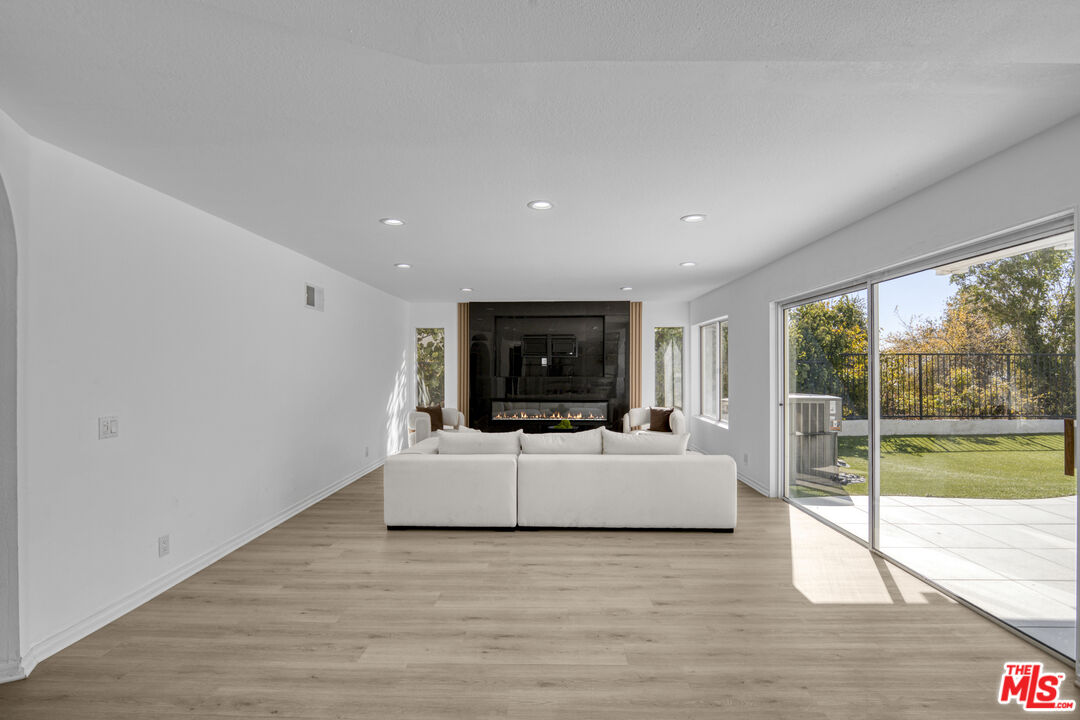 19668 Pine Valley Way Porter Ranch, CA 91326 - Photo 17 of 52 a living room with furniture and a flat screen tv