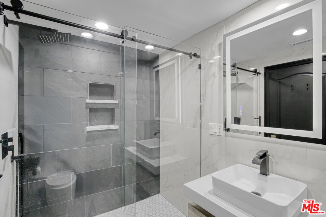 19668 Pine Valley Way Porter Ranch, CA 91326 - Photo 21 of 52 a bathroom with a sink toilet and shower