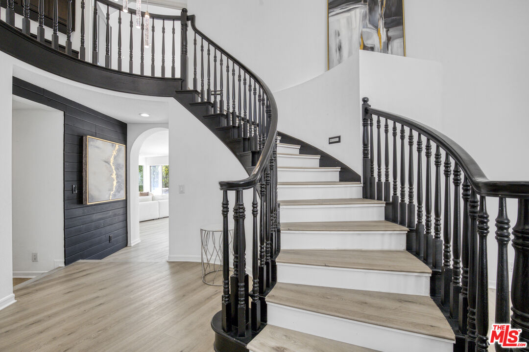 19668 Pine Valley Way Porter Ranch, CA 91326 - Photo 23 of 52 a view of staircase with wooden floor and a rug