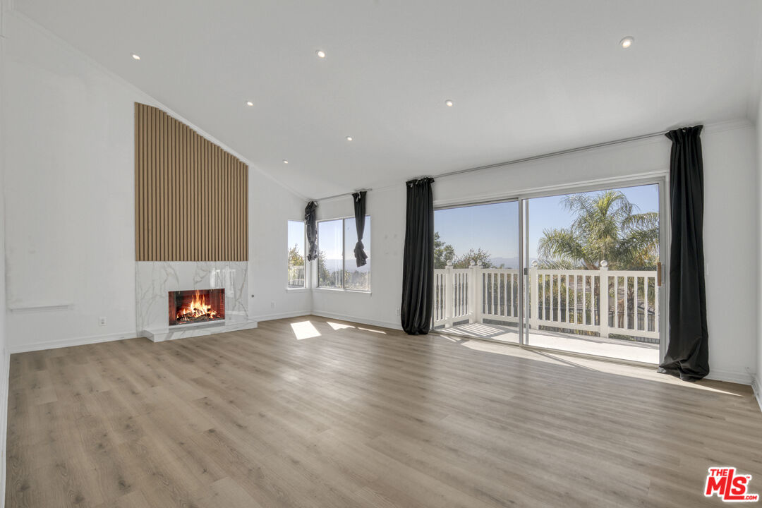 19668 Pine Valley Way Porter Ranch, CA 91326 - Photo 24 of 52 a view of an empty room with a window and wooden floor
