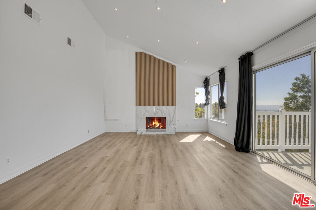19668 Pine Valley Way Porter Ranch, CA 91326 - Photo 25 of 52 a view of a livingroom with wooden floor and a fireplace