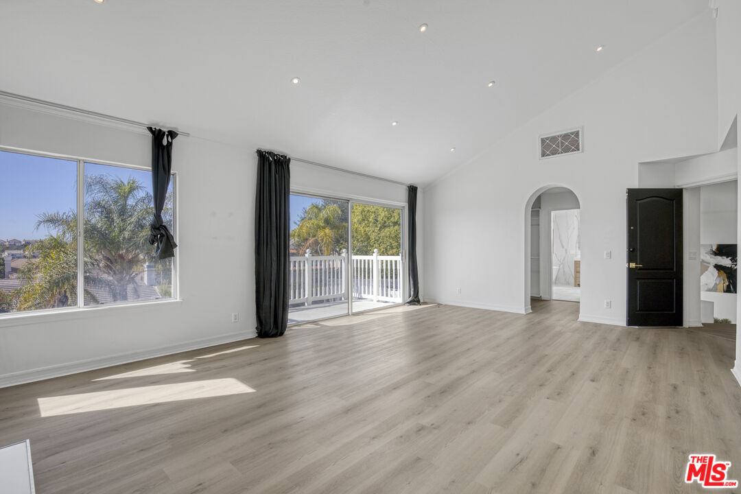 19668 Pine Valley Way Porter Ranch, CA 91326 - Photo 26 of 52 a view of a big room with wooden floor and windows