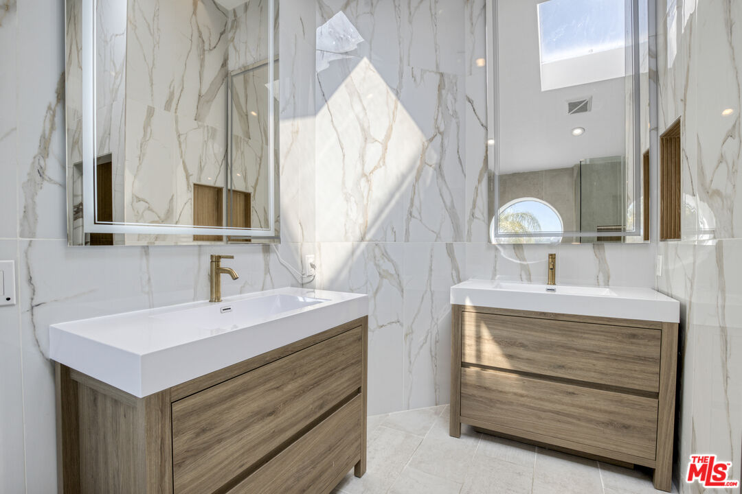 19668 Pine Valley Way Porter Ranch, CA 91326 - Photo 29 of 52 a bathroom with a sink double vanity and a mirror