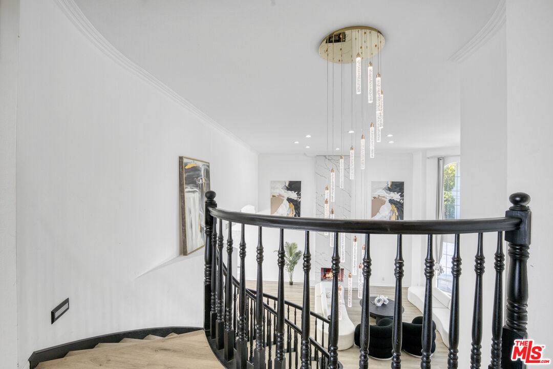 19668 Pine Valley Way Porter Ranch, CA 91326 - Photo 36 of 52 a view of a hallway with bed and wooden floor