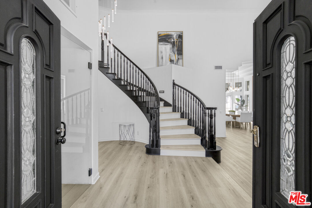 19668 Pine Valley Way Porter Ranch, CA 91326 - Photo 4 of 52 a view of staircase with lots of frames on wall and windows