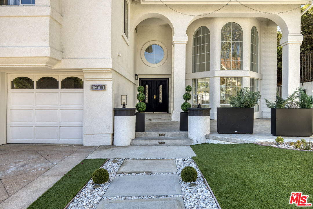 19668 Pine Valley Way Porter Ranch, CA 91326 - Photo 44 of 52 a front view of a house with garden