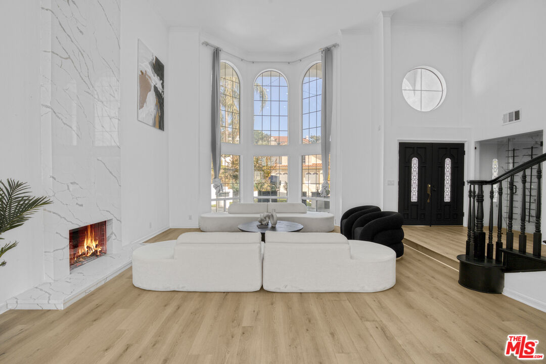 19668 Pine Valley Way Porter Ranch, CA 91326 - Photo 9 of 52 a living room with furniture and a large window