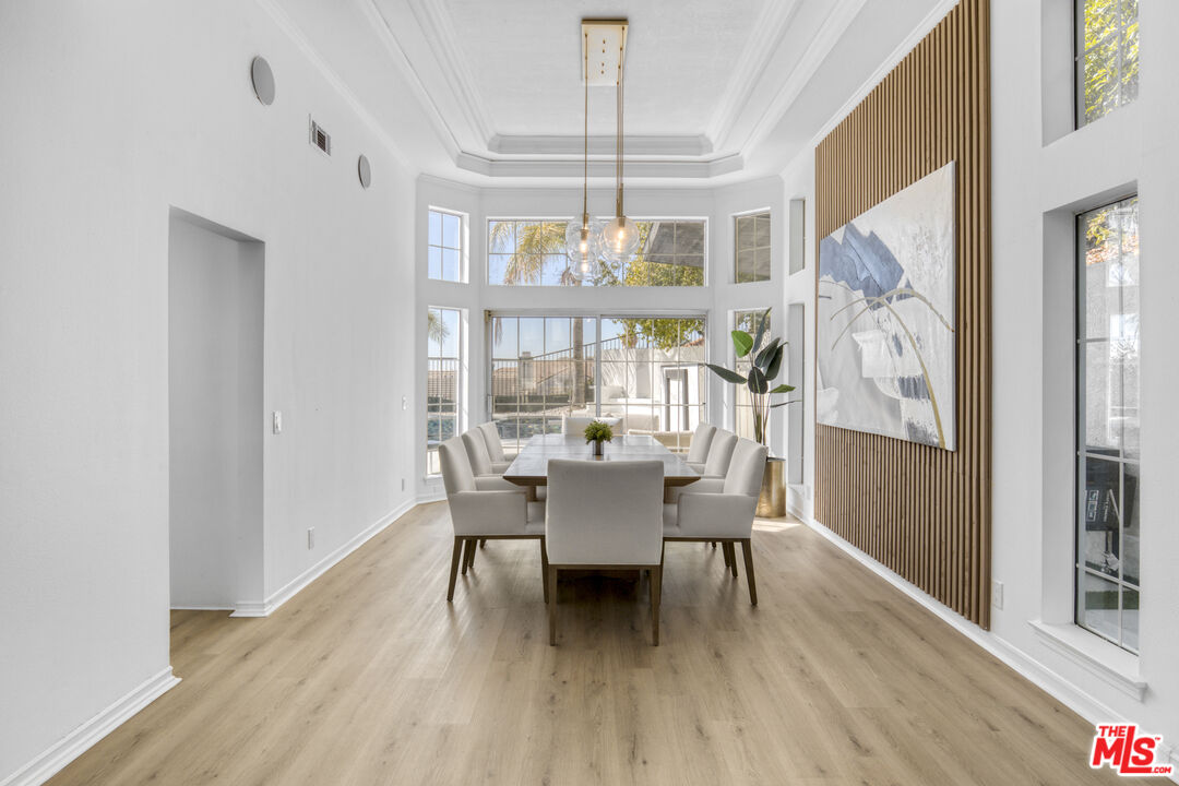19668 Pine Valley Way Porter Ranch, CA 91326 - Photo 10 of 52 a dining room with furniture a chandelier and wooden floor