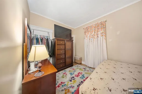 a bedroom with a bed and a large mirror