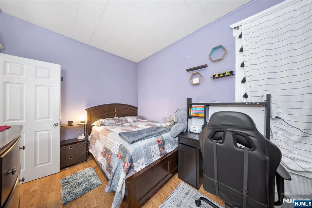 409 Hamilton Street Harrison, NJ 07029 - Photo 18 of 44 a bedroom with a bed and a window