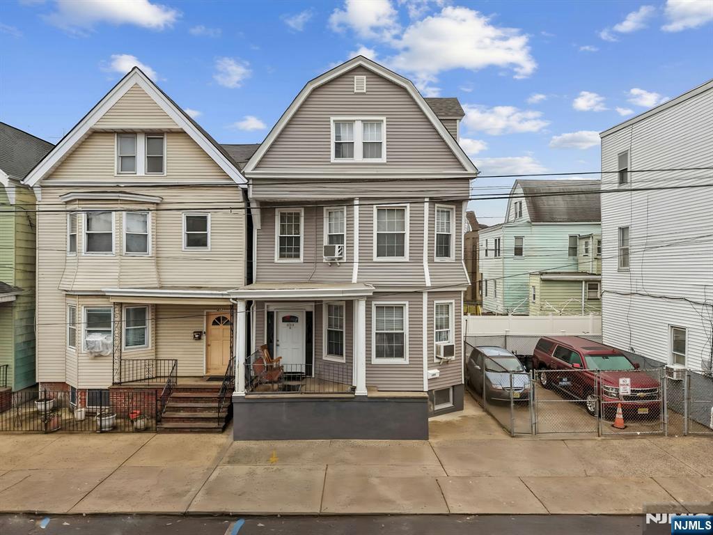 409 Hamilton Street Harrison, NJ 07029 - Photo 2 of 44 a view of multiple houses with cars parked