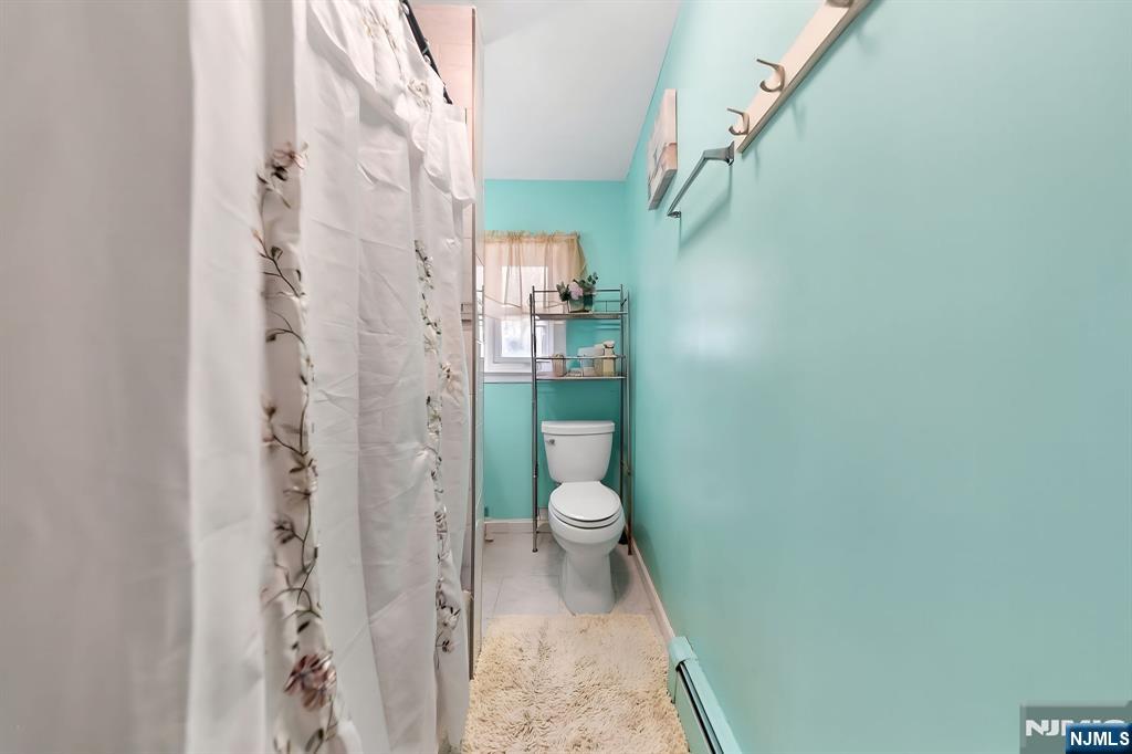 409 Hamilton Street Harrison, NJ 07029 - Photo 27 of 44 a bathroom with a granite countertop shower and a toilet