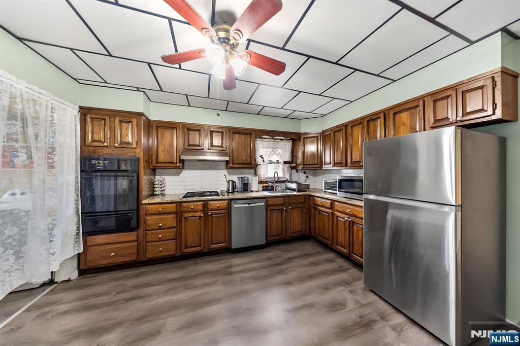 409 Hamilton Street Harrison, NJ 07029 - Photo 28 of 44 a kitchen with stainless steel appliances granite countertop a refrigerator a stove a sink and dishwasher