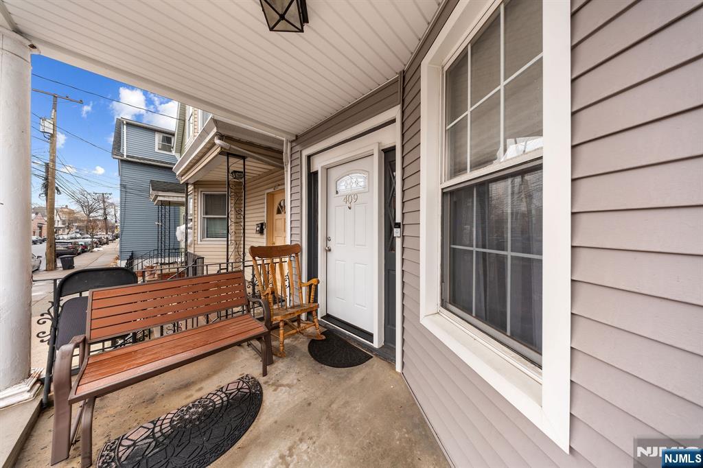 409 Hamilton Street Harrison, NJ 07029 - Photo 3 of 44 a view of backyard with a large window and wooden fence