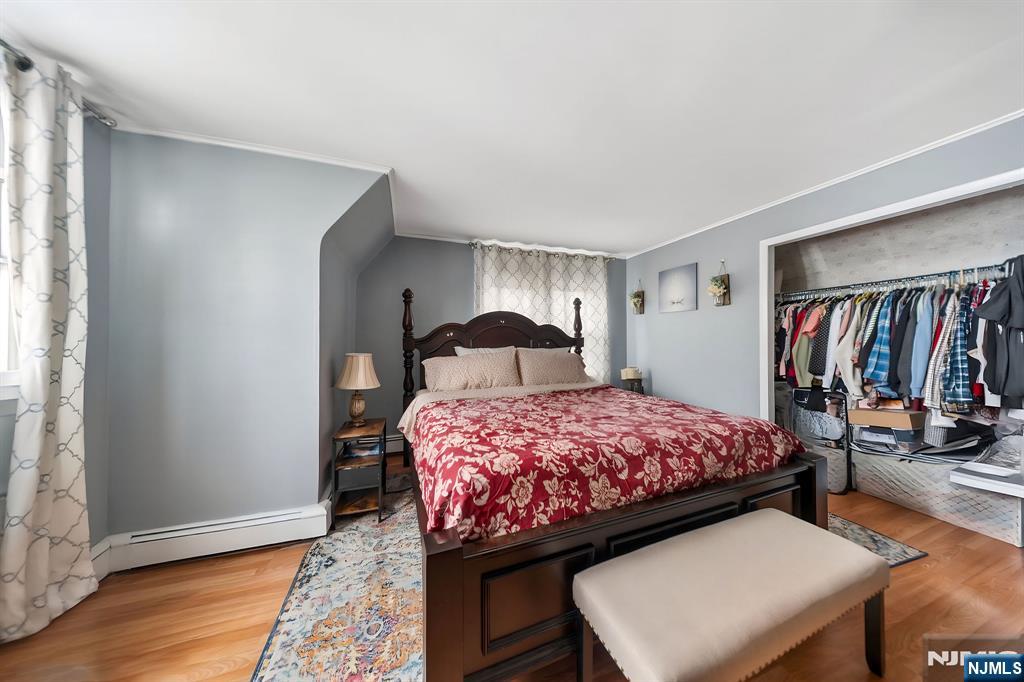 409 Hamilton Street Harrison, NJ 07029 - Photo 32 of 44 a bedroom with a bed and a window