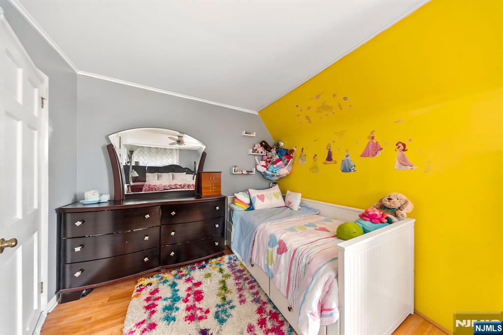 409 Hamilton Street Harrison, NJ 07029 - Photo 33 of 44 a bedroom with a bed and a dresser