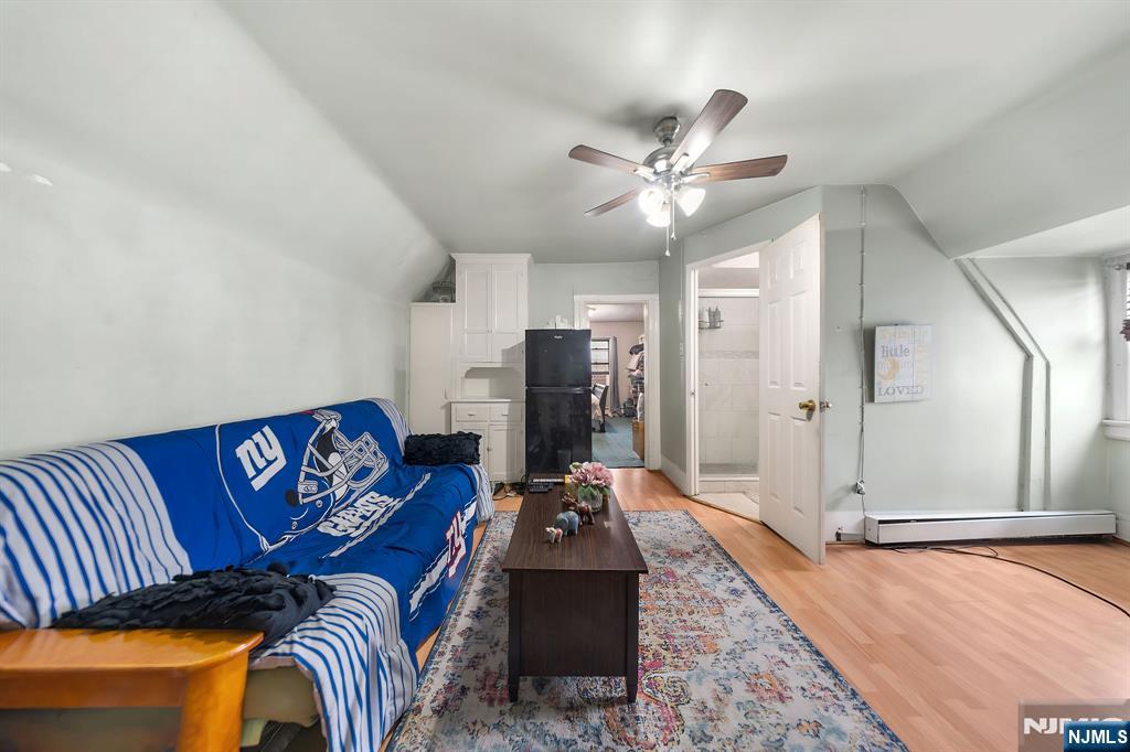 409 Hamilton Street Harrison, NJ 07029 - Photo 36 of 44 a living room with furniture and a chandelier