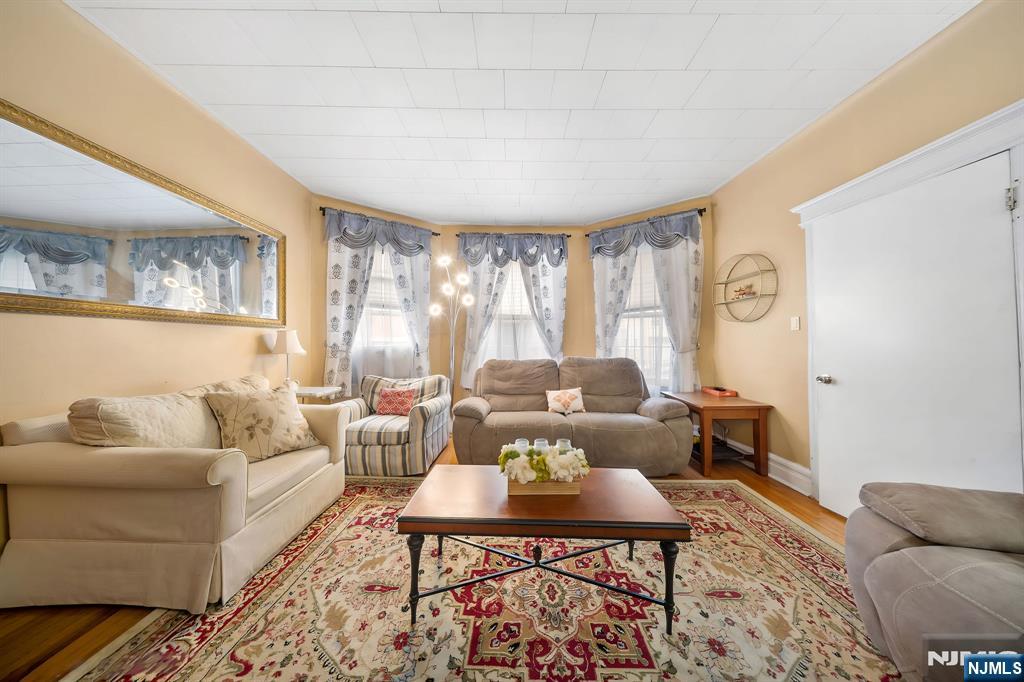 409 Hamilton Street Harrison, NJ 07029 - Photo 7 of 44 a living room with furniture and a large window