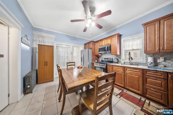 a large kitchen with a table and chairs in it