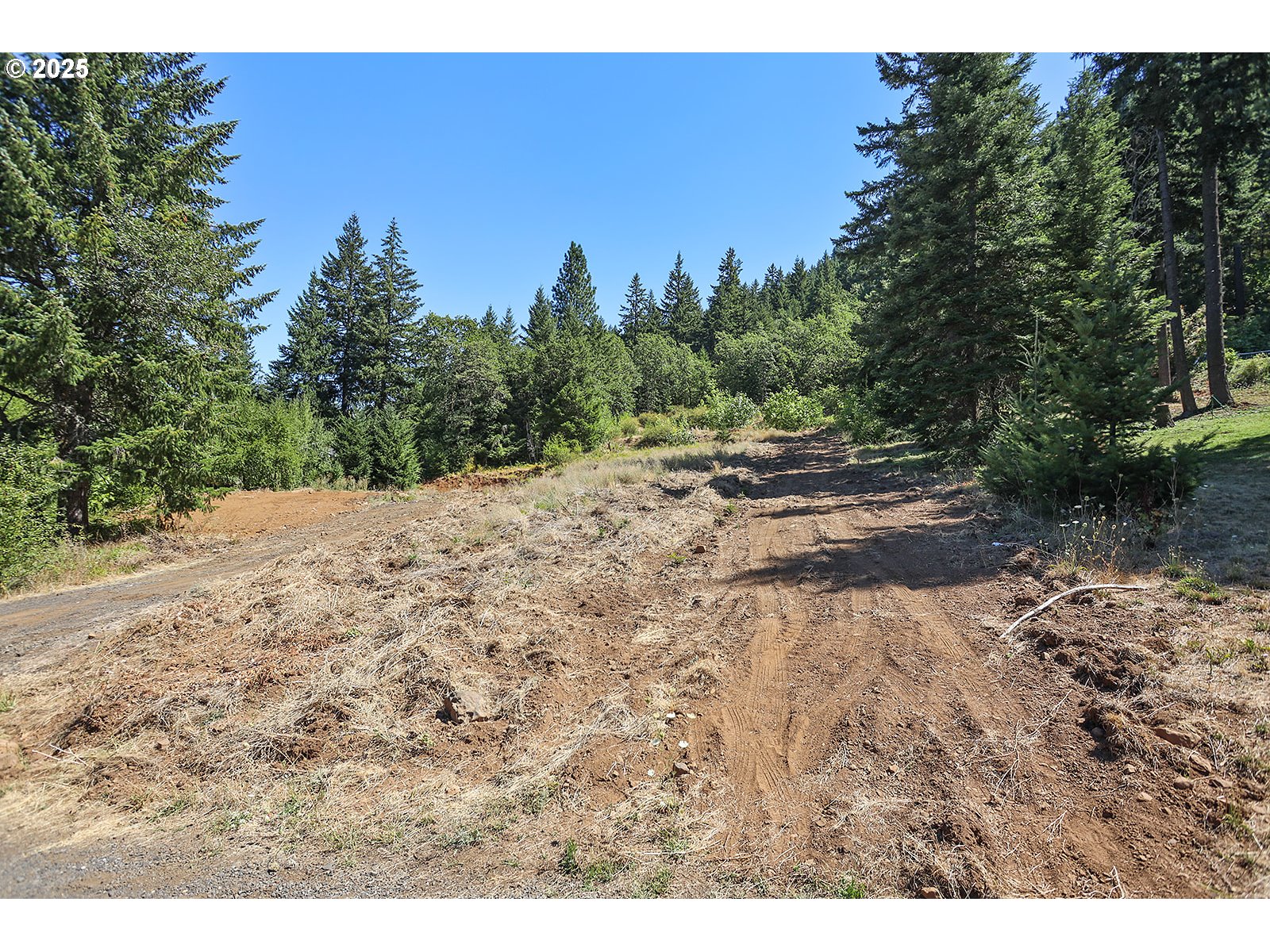 3355 James Road Hood River, OR 97031 - Photo 6 of 19 a view of a dirt road with trees in the background