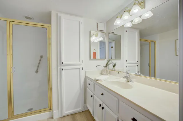 a bathroom with a sink vanity and a mirror