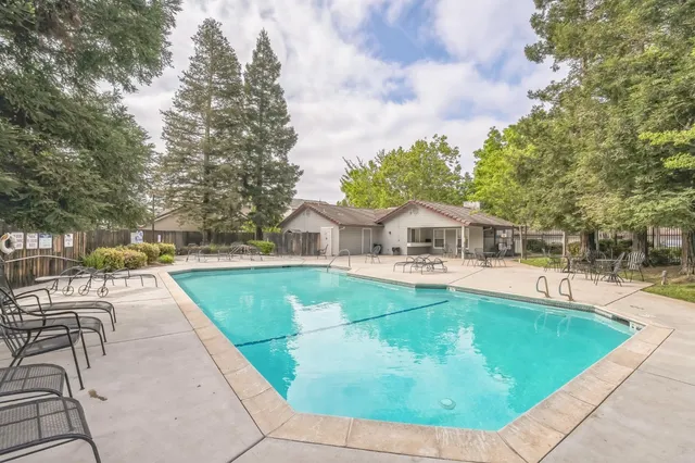a view of a swimming pool with sitting area