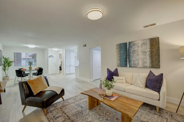 a living room with furniture and wooden floor