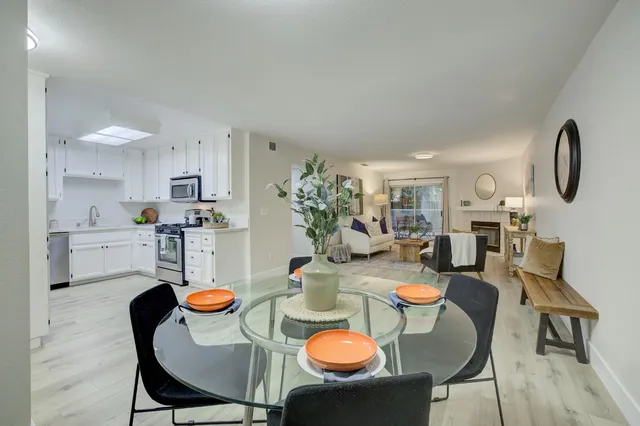 a dining room with furniture and wooden floor