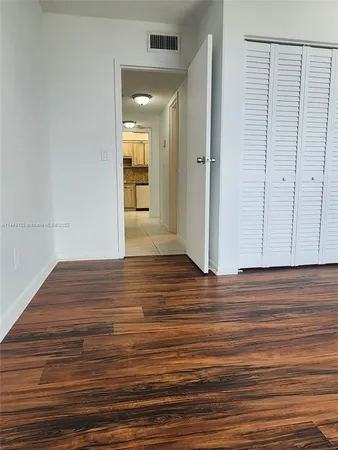 a view of a room with wooden floor