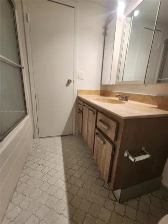 a view of a kitchen with a sink and wooden floor