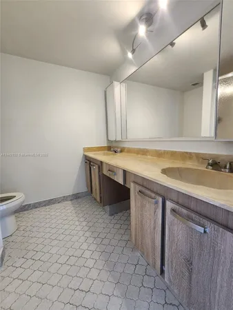 a view of hallway with closet and cabinet