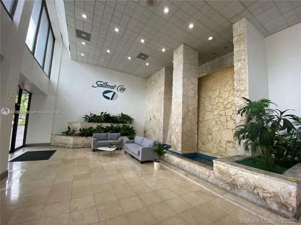 a lobby with furniture and potted plant