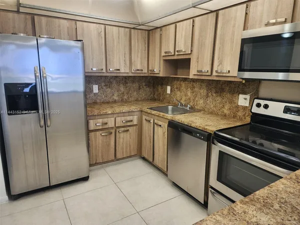 a kitchen with a sink stove and microwave