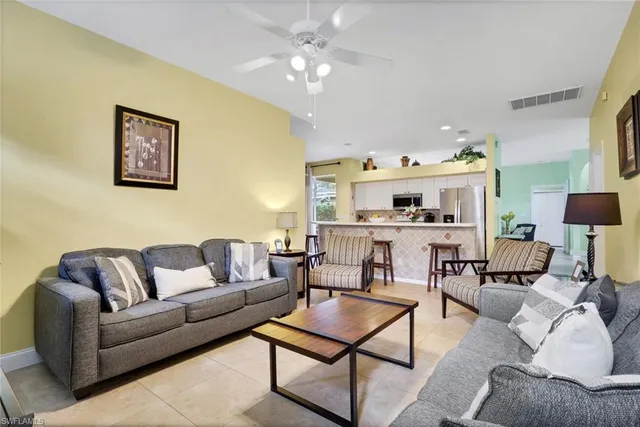 a living room with furniture and kitchen view