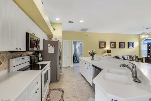 a large bedroom with a large bed a couch and dresser