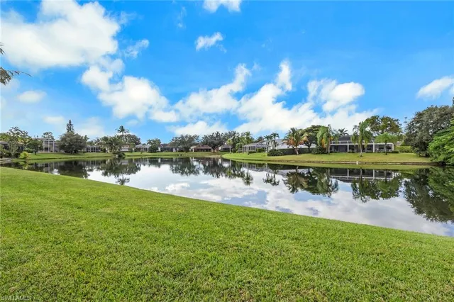 a view of a lake with houses in the back