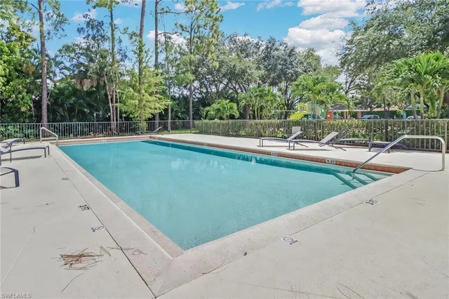 a view of a backyard with swimming pool
