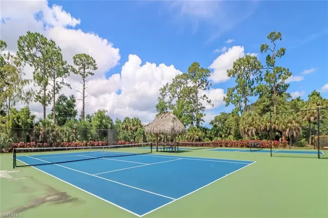 a house view with a swimming pool and sitting space