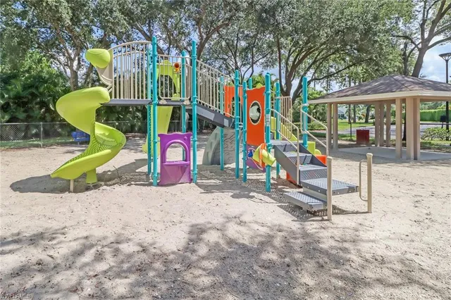 a view of a swimming pool with a lawn chairs under an umbrella