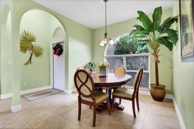 a view of a dining room with furniture and a potted plant