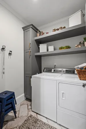 a spacious bedroom with a bed and a chandelier