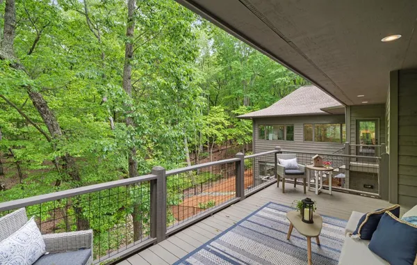 a kitchen with stainless steel appliances kitchen island granite countertop a table chairs and a refrigerator