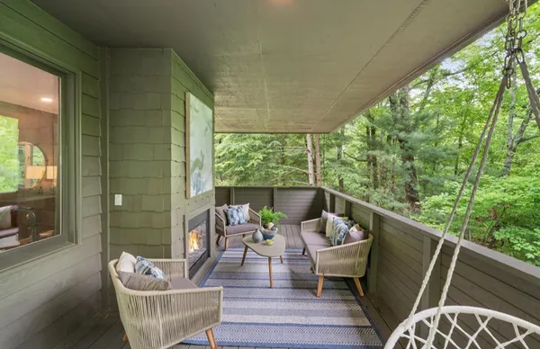 a living room with furniture a bookshelf and a large window