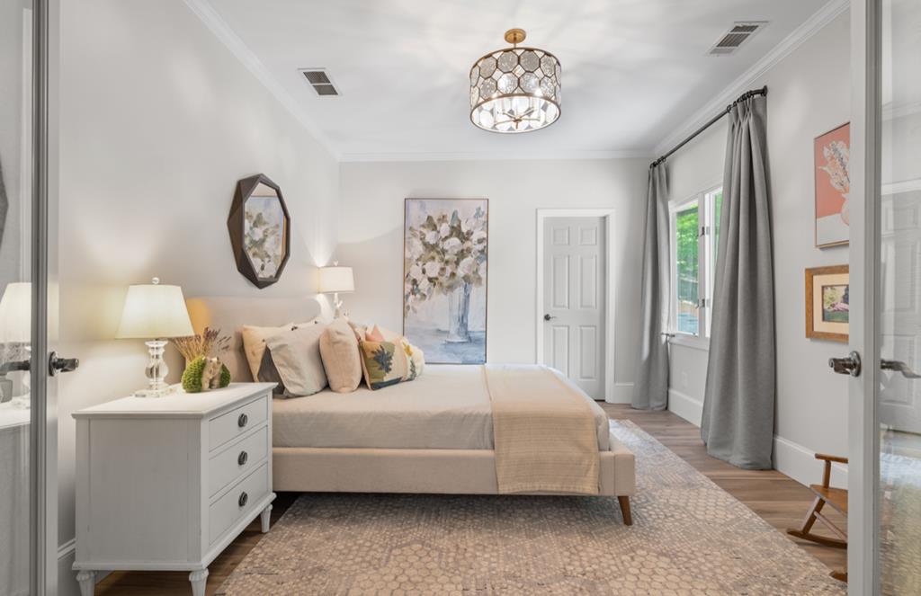 220 Wake Robin Drive Jasper, GA 30143 - Photo 37 of 81 a spacious bedroom with a bed and a chandelier